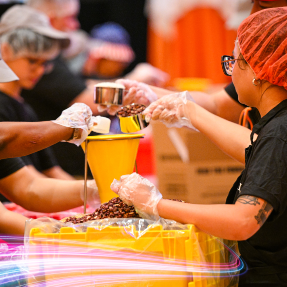people packing food into a box