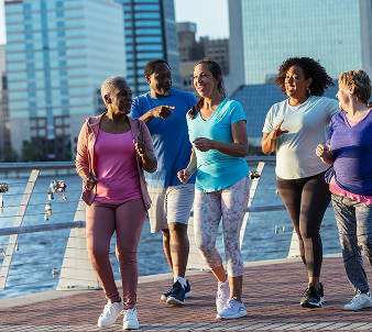 group of people jogging at a waterfront