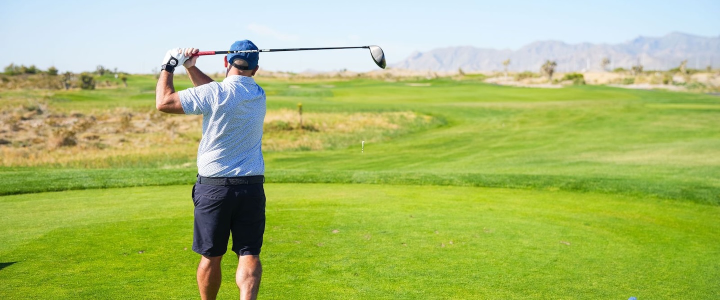 arial shot of golf course with buildings in background