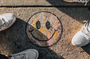 a smiley face drawn on pavement