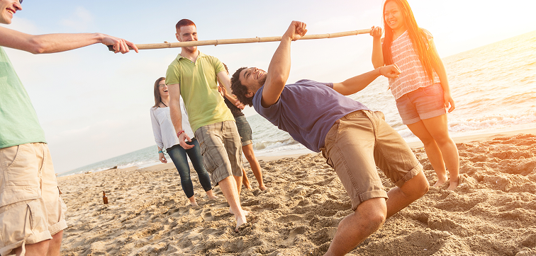 people playing limbo on a sunny beach