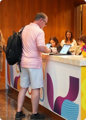 man standing using laptop